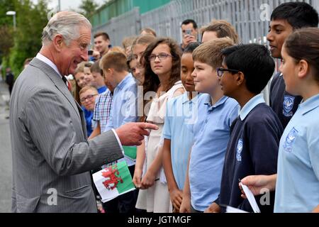 The Prince of Wales is greeted by local school children during a visit to Rachel's Organic in Aberystwyth, a company which produces organic yoghurt, where he will officially open the firm's new extension, before meeting employees. Stock Photo