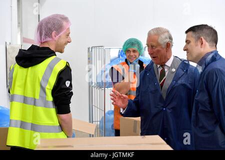 The Prince of Wales speaks to employees during a visit to Rachel's Organic in Aberystwyth, a company which produces organic yoghurt, where he will officially open the firm's new extension. Stock Photo