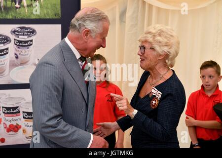The Prince of Wales is joined by Rachel Cooper (right), founder of Rachel's Organic, during a visit to Rachel's Organic in Aberystwyth, a company which produces organic yoghurt, where he will officially open the firm's new extension, before meeting employees. Stock Photo