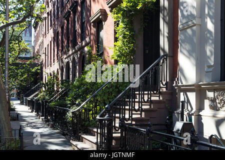 Empty sidewalk in front of historic brownstone buildings in the Gramercy Park neighborhood of Manhattan in New York City NYC Stock Photo