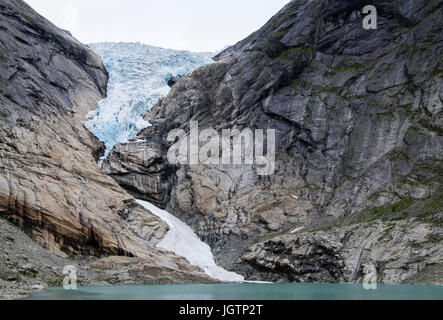 Briksdalsbreen or Briksdal glacier is an arm of Jostedalsbreen glacier above Briksdalsbrevatnet glacial lake in Jostedalsbreen National Park Norway Stock Photo