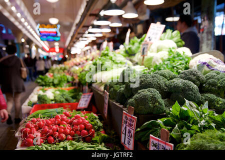 SEATTLE, WASHINGTON, USA - JAN 24th, 2017: Vegetables for sale in the high stalls at the Pike Place Market. This farmer market is a famous sight in downtown. Stock Photo