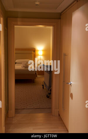 VIENNA, AUSTRIA - APR 30th, 2017: King sized bed in a luxury hotel room with an lounge chair at the Penthouse Suite at the Hilton Vienna Stock Photo