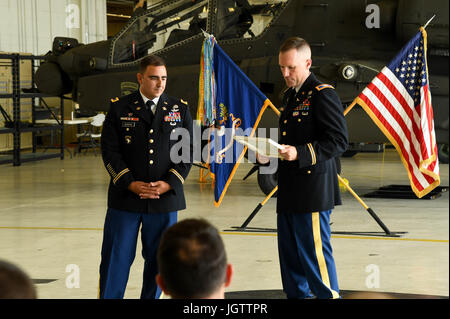 Col. Bernard Harrington, the commander of the 82nd Combat Aviation Brigade, presents an award to Chief Warrant Officer 4 James Morrow, a flight instructor from Fort Rucker, June 30, 2017 at Fort Campbell, Ky. Both Harrington and Morrow formerly served with the  1st Battalion, 101st Aviation Battalion, 101st Combat Aviation Brigade and returned to Fort Campbell to celebrate Morrow's retirement. (U.S. Army photo by Sgt. Marcus Floyd, 101st Combat Aviation Brigade) Stock Photo