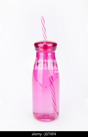 Pink plastic tumbler on a white surface. Tumbler isolated on white background. Stock Photo