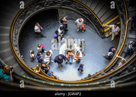 A photographer shoots visitors downstairs the Spiral staircase to Vatican Museum, Every year millions of tourists descend this famous flight of steps. Stock Photo