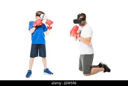 side view of father and son boxing in virtual reality headsets isolated on white Stock Photo