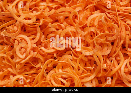 background image of spiral cut sweet potato pieces Stock Photo