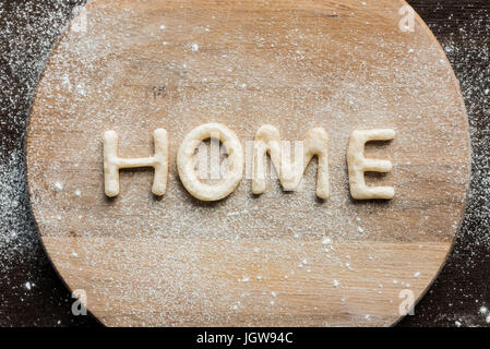 Top view of edible lettering home made from cookies on wooden cutting board, baking cookies concept Stock Photo