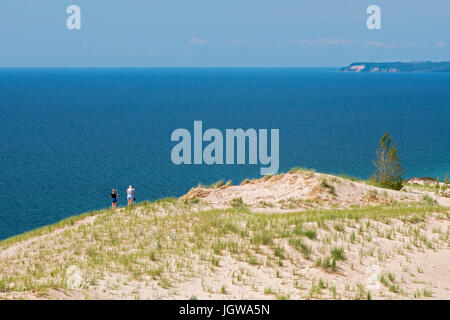 Empire, Michigan - Two women on a sand dune above Lake Michigan in Sleeping Bear Dunes National Lakeshore. Stock Photo