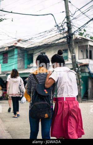 Two girl friends walking in a normal street of Boracay. Stock Photo