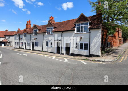 The Little house as it is now known has a row of terraced houses alongside the main road through the village in this quiet village location. Stock Photo