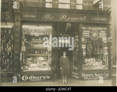 Late 1920's postcard (cropped proof) of The Regent confectioner and tobacconists shop selling sweets and tobacco products, owner or staff standing outside, licensed to W. J. Marriott, 35 High Street, U.K.(possibly Suffolk) Stock Photo