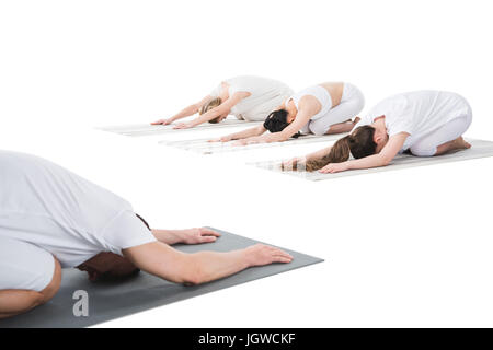 Woman doing Asthanga Vinyasa Yoga asana Yoga mudrasana (yoga mudra) -  psychic union pose isolated on white background - SuperStock