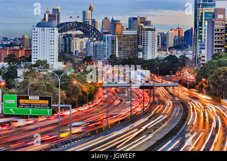 Long exposure blurred vehicle motion on multi-lane Warringah freeway going through North Sydney in Sydney, Australia. Headlights and backlights during Stock Photo