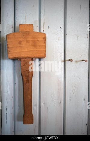 Wooden mallett hanging on workshop wall Stock Photo