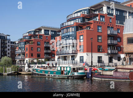 Barges including the Lady Phantasie on the River Thames in Kingston Upon Thames.  Garricks House development of luxury riverside apartments. Stock Photo