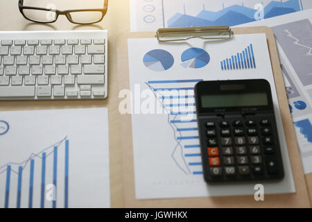 Checking financial reports paperwork and Business  Teamwork on table calculating or checking balance Stock Photo
