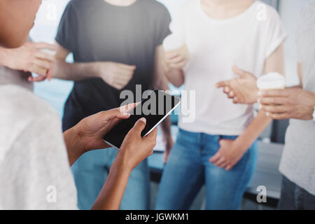 Team of businessmen view project on tablet. Concept of cooperation and technology Stock Photo