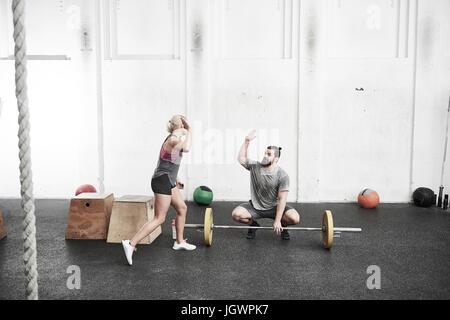 Couple giving high five in cross training gym Stock Photo