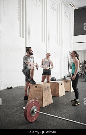 Friends chatting in cross training gym Stock Photo