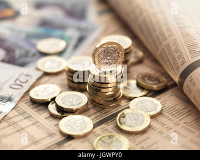 Still life of British currency on financial newspaper, close-up