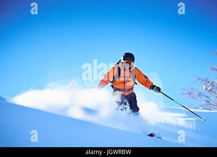 Man skiing down snow covered mountainside, Aspen, Colorado, USA Stock Photo