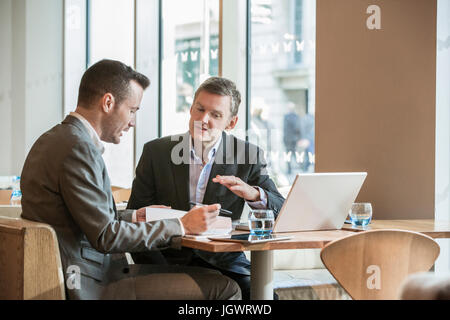 Businessmen working in cafe Stock Photo