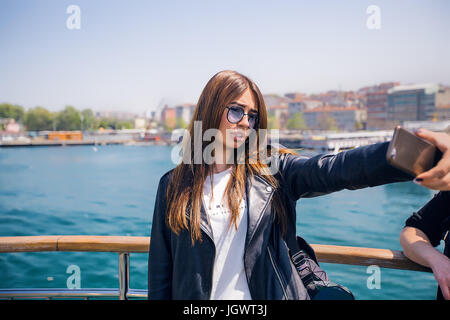 Woman taking selfie, sea in background Stock Photo