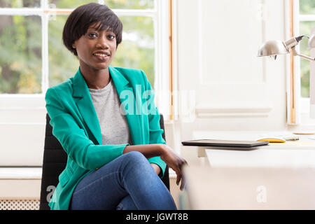 Portrait of female designer at desk in creative studio Stock Photo