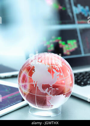 Globe with digital tablet and laptop showing international business trade Stock Photo