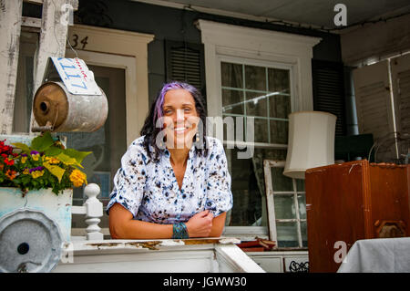Portrait of female shop keeper in front porch shabby chic shop Stock Photo
