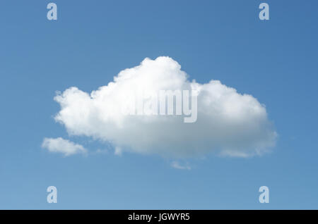 A large white fluffy cloud floating in a blue sky. Stock Photo