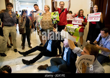 Washington, USA. 10th July, 2017. People participate in a protest against Republican health care bill in Russell Senate Office Building on Capitol Hill in Washington, DC, the United States, July 10, 2017. Over 100 protestors from at least 21 states who are afraid of losing their health care participated in the protest here on Monday. Credit: Ting Shen/Xinhua/Alamy Live News Stock Photo