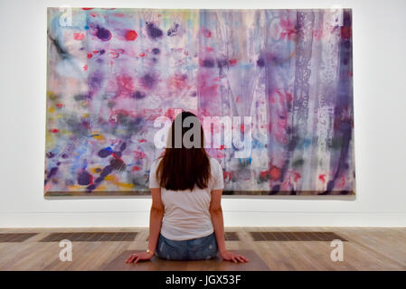 London, UK. 11th July, 2017. A staff member views 'April 4', 1969, by Sam Gilliam. Preview of 'Soul of a Nation: Art in the Age of Black Power' at the Tate Modern. The landmark exhibition explores what it meant to be a Black artist in the USA during the Civil Rights movement and features more than 150 works by over 60 artists. The works are on display 12 July to 22 October 2017. Credit: Stephen Chung/Alamy Live News Stock Photo