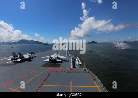 Hong Kong, China. 11th July, 2017. China's first aircraft carrier, the Liaoning, leaves after wrapping up a five-day visit to the Hong Kong Special Administrative Region (SAR), south China, July 11, 2017. A departure ceremony was held at the Ngong Shuen Chau Barracks of the People's Liberation Army (PLA) Hong Kong Garrison by the HKSAR government. Credit: Zeng Tao/Xinhua/Alamy Live News Stock Photo