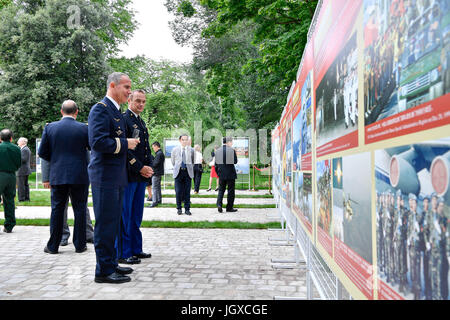 Paris, France. 11th July, 2017. Guests watch a photo exhibition marking the 90th anniversary of the founding of the People's Liberation Army of China (PLA) in Paris, France, July 11, 2017. Credit: Chen Yichen/Xinhua/Alamy Live News Stock Photo