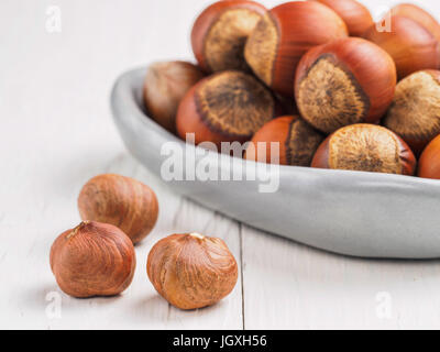 Close up view on hazelnut on white wooden background with copy space Stock Photo