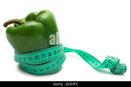 Vegetable diet. Green bell pepper (bulgarian) tighten measuring tape isolated on white. Stock Photo