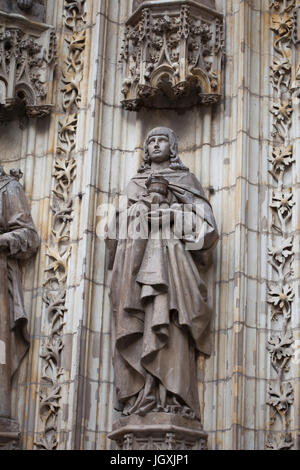 Saint John the Evangelist. Statue on the Portal of the Assumption (Puerta de la Asunción) of the Seville Cathedral (Catedral de Sevilla) in Seville, Andalusia, Spain. Stock Photo