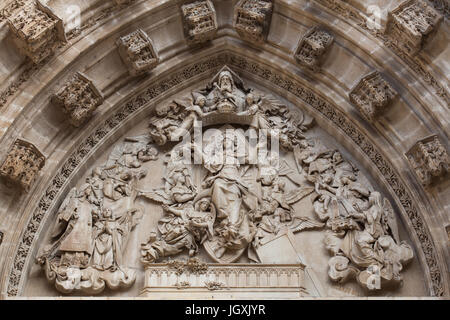 Assumption of Mary. Tympanum by Spanish sculptor Ricardo Bellver (1882) on the Portal of the Assumption (Puerta de la Asunción) of the Seville Cathedral (Catedral de Sevilla) in Seville, Andalusia, Spain. Stock Photo