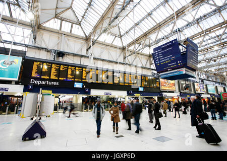 London, UK - November 18, 2012: Inside view of Waterloo Station, people present, since 1848, central London railway terminus, busiest railway terminus Stock Photo