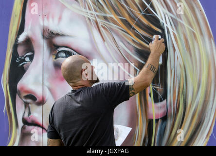 An artist is pictured working at the Upfest 2016 festival,Europe's largest Street Art & Graffiti festival is pictured on the streets of Bristol. Stock Photo