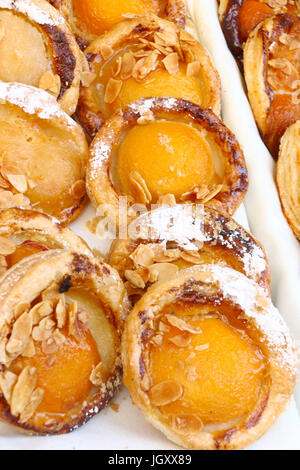 Apricot mini tarts with almond slices, seen at a street fair celebrating Bastille Day in NYC Stock Photo