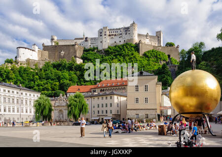 Hohensalzburg Castle and Chapter Square (Kapitelplatz) with sculpture 'Sphaera' by Stephan Balkenhol - Salzburg, Austria Stock Photo