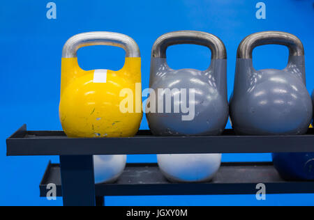 colorful kettlebells in a row in a gym Stock Photo