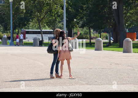 Two women taking selfie using smartphone - USA Stock Photo