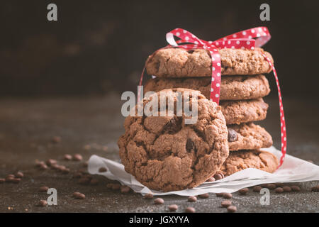 Stack of freshly baked chocolate chip cookies on rustic background Stock Photo