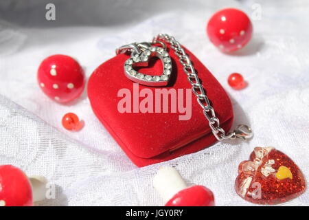 velevet red box with shine heart on top with ring inside Stock Photo