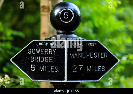 Canal side distance marker on the Rochdale Canal near Hebden Bridge, West Yorkshire, UK Stock Photo